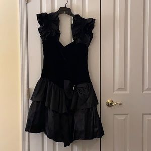 Black Ruffled sleeve and skirt evening dress with rhinestone embellished bow.